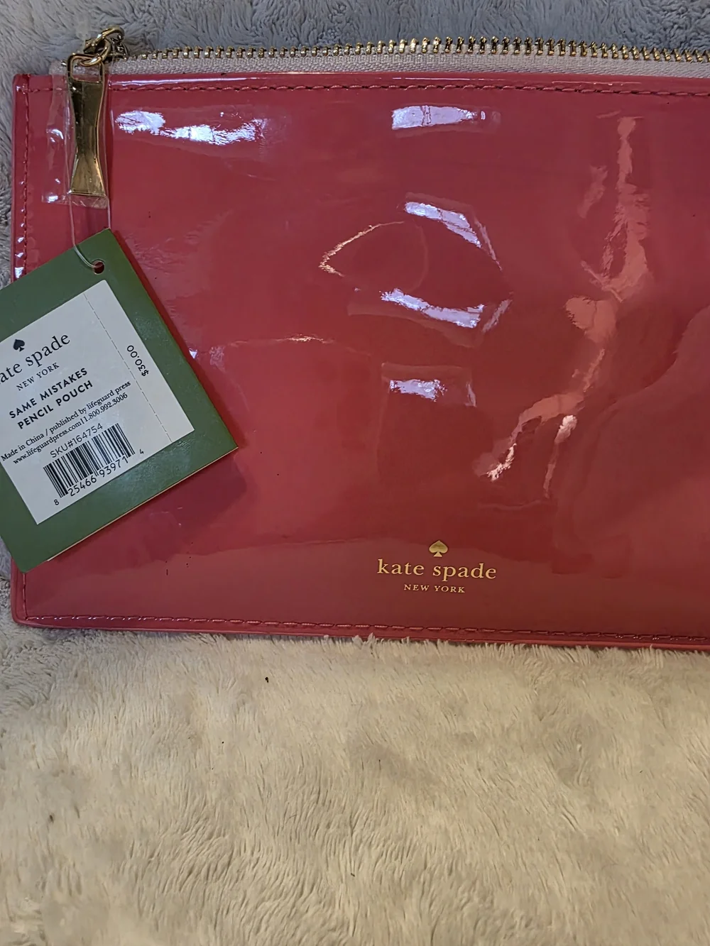 kate spade glossy hot pink zip pouch with gold logo